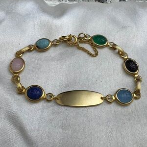 Vintage Gold Tone Scarab Bracelet with Multicolor Carved Glass.